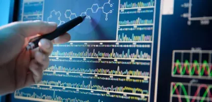 image of a hand holding a pen pointing at a screen with analytics 