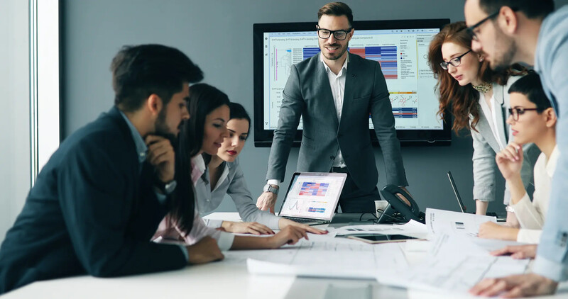 A group of business professionals in a meeting room
